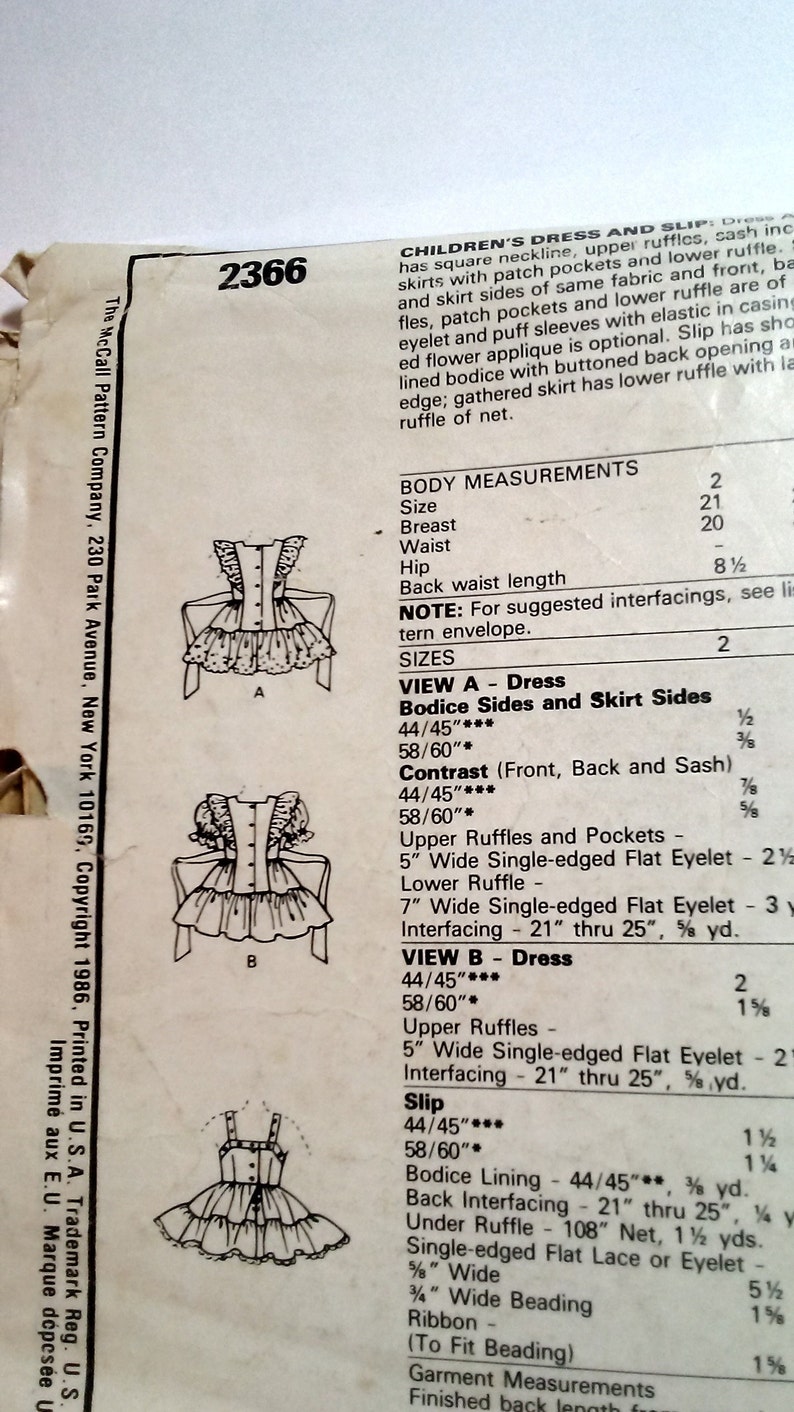 May include: Sewing pattern for a children's dress and slip. The pattern includes instructions for making a dress with a square neckline, upper ruffles, patch pockets, and a lower ruffle. The slip has a gathered skirt with a lower ruffle. The pattern includes measurements for sizes 2, 20, and 21.