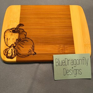 Bamboo cutting/charcuterie board with woodburn design.
