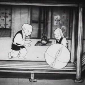 May include: A black and white image of two people in a room. The person on the left is wearing a long-sleeved shirt and pants. The person on the right is wearing a dress and holding a large, round object.