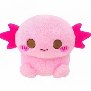 Może przedstawiać: R&oacute;żowa pluszowa zabawka axolotl z brązowymi oczami i r&oacute;żowymi falbankami. Axolotl siedzi na pupie z nogami schowanymi pod spodem.