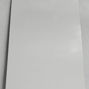 May include: A plain white sheet of paper.