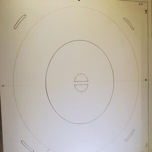 May include: A white, rectangular surface with concentric circles and curved lines, possibly a template or guide. The image includes the text "Showcase Prims" and a graphic of a hat.
