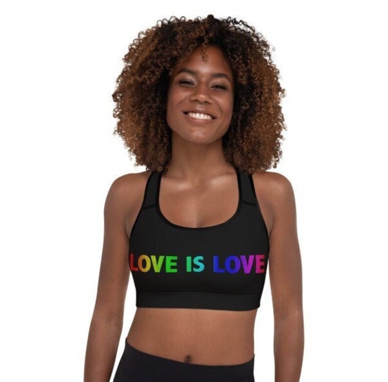 May include: A black sports bra with rainbow lettering that reads "LOVE IS LOVE".