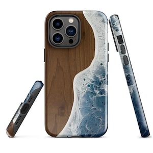 May include: A phone case with a wood grain design on one side and a blue and white wave design on the other side.