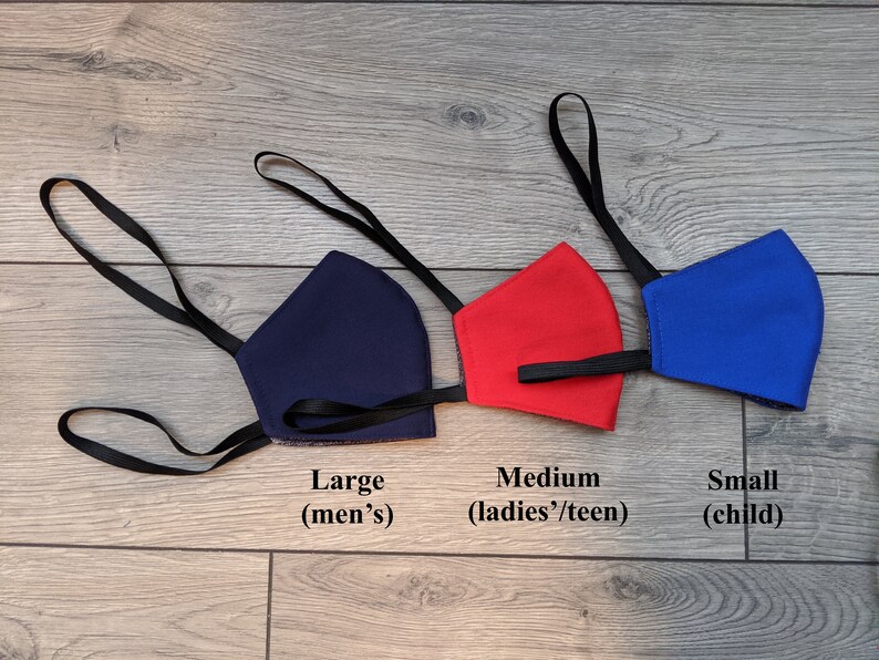 May include: Three face masks in different sizes, navy blue, red, and blue, with black elastic straps. The masks are labeled "Large (men's)", "Medium (ladies'/teen)", and "Small (child)".