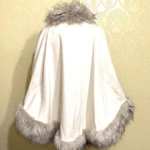 May include: White faux fur trim poncho with a gray faux fur collar and trim.