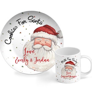 May include: A white ceramic plate with a red and white illustration of Santa Claus. The plate has the text "Cookies For Santa" and "Love, Everly & Jordan". A white ceramic mug with a red and white illustration of Santa Claus. The mug has the text "Milk For Santa" and "Love, Lucy and Maggie".