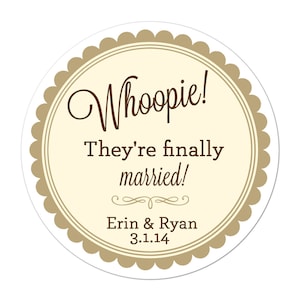 May include: A round sticker with a scalloped edge and a cream-colored center. The text "Whoopie! They're finally married!" is written in brown script and block letters. The names "Erin & Ryan" and the date "3.1.14" are also included.
