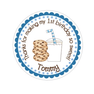 May include: Round blue and white thank you sticker with a blue and white striped straw, a glass of milk, and a stack of chocolate chip cookies. The text on the sticker reads "Thanks for making my 1st birthday so sweet! Tommy"
