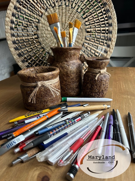 Hand-sculpted papier-mâché pen holder with an intentionally imperfect wabi-sabi form — genuinely artisanal, tactile, and a desk object with actual soul.