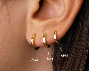 May include: Three gold hoop earrings in different sizes: 6 mm, 7 mm, and 8 mm. The earrings are shown on a person's ear.