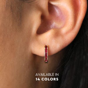 May include: Gold hoop earrings with a row of red rectangular gemstones. Available in 14 colours.