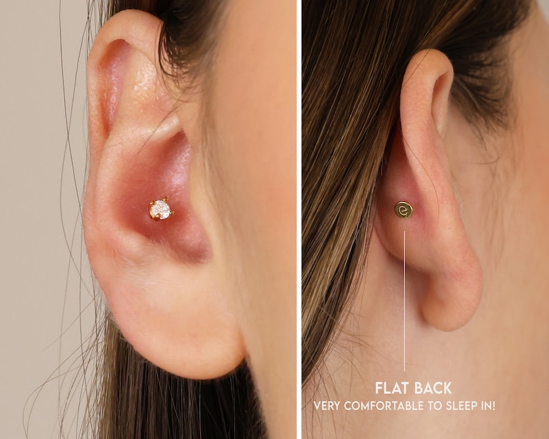 May include: Close-up of a person's ear with a small, clear, round gemstone stud earring. The earring has a flat back, making it comfortable to sleep in.