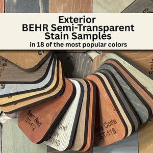 May include: A collection of BEHR Exterior Semi-Transparent Stain Samples in various wood tones. The samples are arranged in a fan shape, showcasing 18 popular colors. Each sample is labeled with its color name and code, such as "Barn Red ST-112".