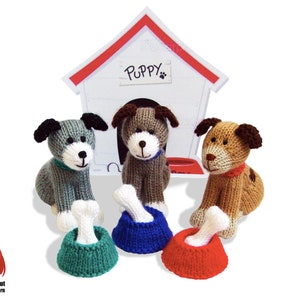 May include: Three knitted dog toys with bones and bowls. The dogs are gray, brown, and tan. The bowls are green, blue, and red. The sign above the dogs says "Puppy".