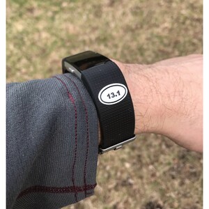 May include: A black fitness tracker with a white sticker that says "13.1" on it.