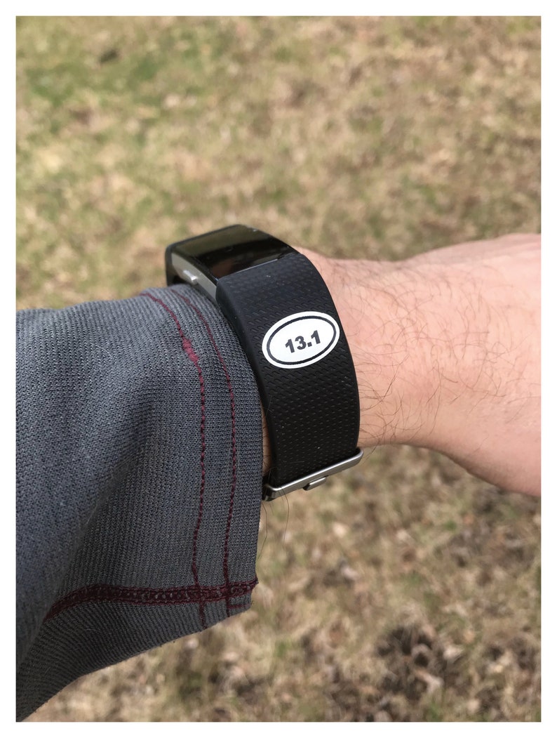 May include: A black fitness tracker with a white sticker that says "13.1" on it.