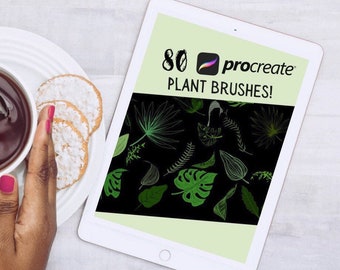以下が含まれることがあります： 緑色の背景に80個のProcreate植物ブラシのセットが表示された白いタブレット。タブレットには「80 Procreate Plant Brushes!」というテキストが表示されています。