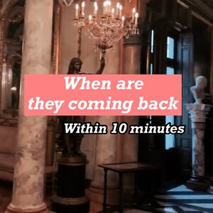 May include: A large, ornate chandelier hangs from the ceiling of a grand room. A statue of a woman holding a torch stands in the foreground. The text "When are they coming back Within 10 minutes" is superimposed on the image.