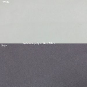 May include: Close-up of a white and grey fabric swatch. The fabric is a poly-cotton blend. The text "lindakale poly-cotton fabric" is printed on the swatch.