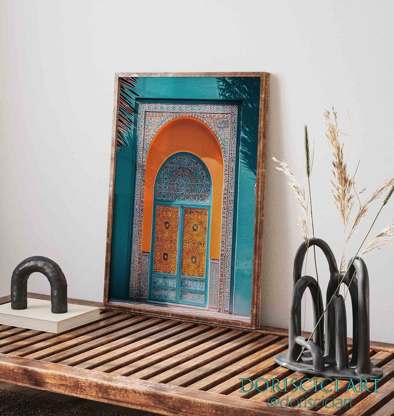 May include: A framed print of a colorful archway with a teal blue background, orange arch, and a blue and yellow patterned door. The archway is decorated with intricate tile work.