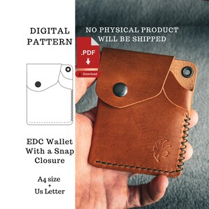 May include: A brown leather EDC wallet with a snap closure, held in a hand. The wallet has a stitched edge and a stamped design. Text on the left side reads "DIGITAL PATTERN" and "EDC Wallet With a Snap Closure". The text "NO PHYSICAL PRODUCT WILL BE SHIPPED" is also visible.