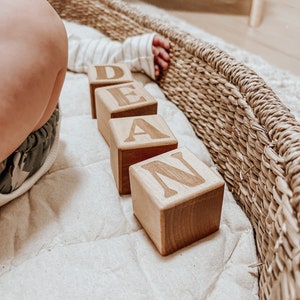 Non-toxic wooden blocks that have an engraving of a custom name. An item you can gift as a baby shower.