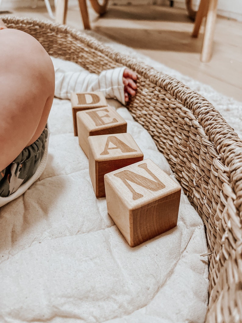 Non-toxic wooden blocks that have an engraving of a custom name. An item you can gift as a baby shower.