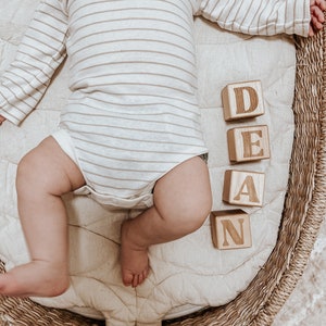 Non-toxic wooden blocks that have an engraving of a custom name. An item you can gift as a baby shower.