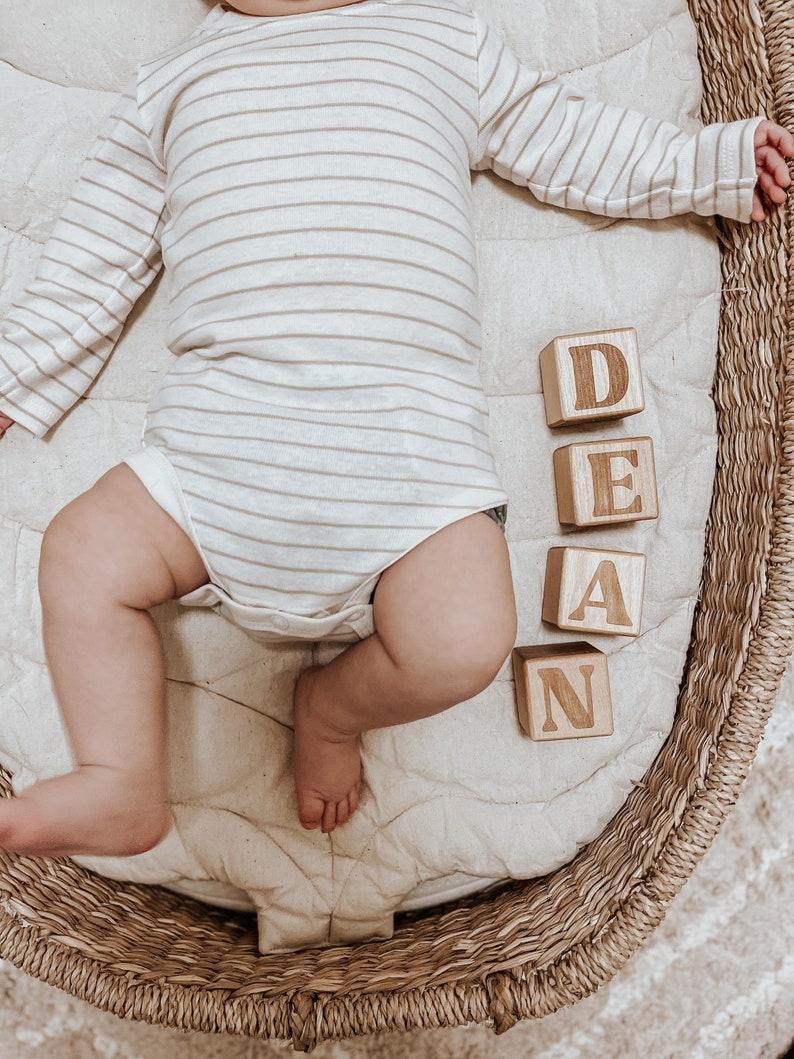 Non-toxic wooden blocks that have an engraving of a custom name. An item you can gift as a baby shower.