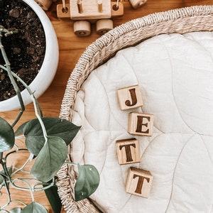 Non-toxic wooden blocks that have an engraving of a custom name. An item you can gift as a baby shower.