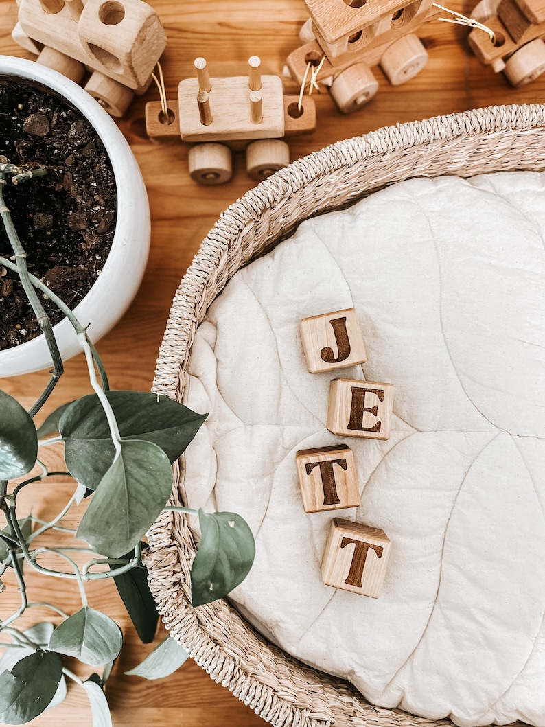 Non-toxic wooden blocks that have an engraving of a custom name. An item you can gift as a baby shower.