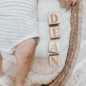 Non-toxic wooden blocks that have an engraving of a custom name. An item you can gift as a baby shower.