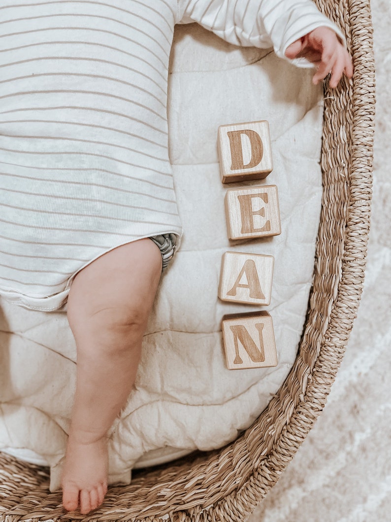 Non-toxic wooden blocks that have an engraving of a custom name. An item you can gift as a baby shower.