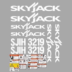 Puede incluir: Logotipo blanco "SKYJACK" y texto "SJII 3219" sobre un fondo gris. Incluye varias etiquetas de advertencia y peligro con ilustraciones y texto. El logotipo tiene un diseño de ala estilizado.
