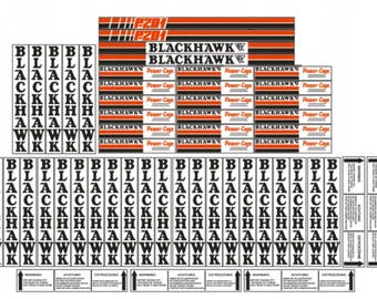 May include: A collection of black and white decals and labels. The decals include the word "BLACKHAWK" in various fonts and sizes, along with the text "Power Cage". There are also individual letter decals.