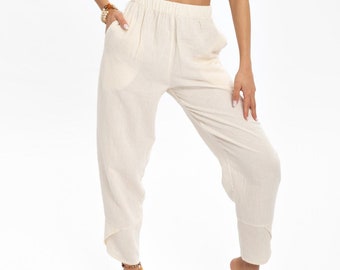 May include: A white strapless crop top and matching wide-leg pants. The outfit is made of a lightweight, textured fabric.