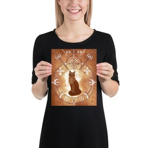 May include: A brown cat sits in the center of a circular geometric design with a gold and brown color scheme. The design is reminiscent of a mandala or a compass.