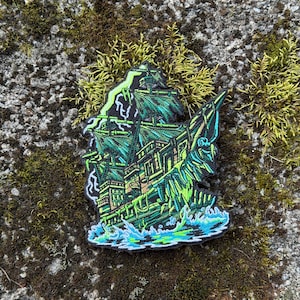 May include: An embroidered patch featuring a detailed depiction of a ghost ship sailing through turbulent waters. The design uses vibrant neon green and teal thread colors against a black background, showcasing tattered sails and a weathered hull.