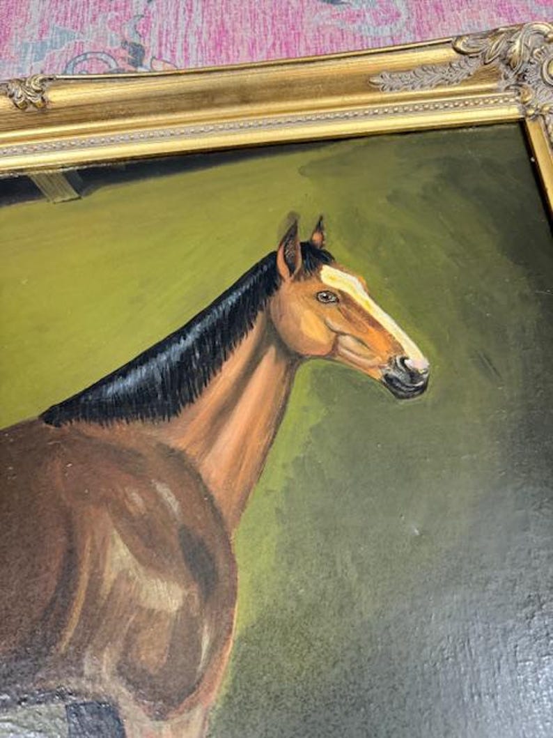 May include: Oil painting of a brown horse with a black mane and a white stripe on its face. The horse is set against a green background and framed in a gold ornate frame. The artwork is a portrait of the horse.