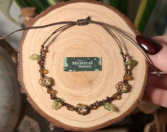Whimsical Nature Themed Adjustable Beaded Bracelet. Glass beaded bracelet on brown waxed cord. Cottagecore fairycore goblincore witchy