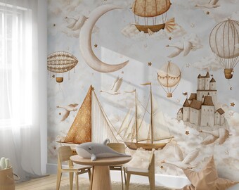 May include: A whimsical nursery scene featuring a wall mural with a dreamy sky, sailboats, hot air balloons, and a castle. A round wooden table with a plush dolphin and two chairs are in front of the mural. A woven basket and a floor pillow complete the room.