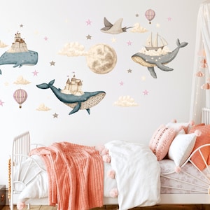 May include: A set of wall decals featuring whimsical illustrations of whales with castles and ships on their backs, floating in the clouds with a full moon and stars. The decals are perfect for a child's bedroom or nursery.