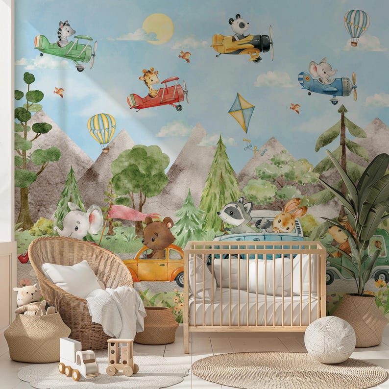 May include: A nursery wall mural with a watercolor design featuring animals in hot air balloons and airplanes. The mural features a raccoon, a rabbit, a giraffe, a panda, a zebra, and a squirrel. The mural is set against a blue sky with white clouds.