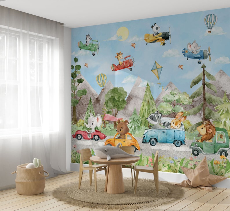 May include: A whimsical nursery wall mural featuring a blue sky with clouds, mountains, and trees.  Animals, including a bear, elephant, raccoon, lion, and rabbit, are driving cars and airplanes.  The mural is perfect for a child's bedroom or playroom.