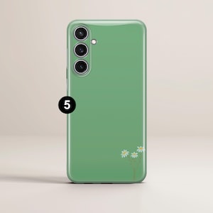 May include: A green phone case with a daisy floral design. The case has a glossy finish and features a camera array on the upper left. The number "5" is printed on the lower left.