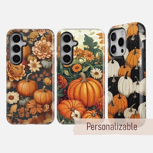 May include: Three phone cases with autumnal designs. The cases feature pumpkins, flowers, and foliage in shades of orange, white, and dark green. One case has the word "Personalizable" on it.