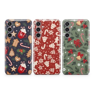 May include: Three phone cases with different Christmas-themed patterns. The first case has a blue background with red and white candy canes, gingerbread cookies, and holly. The second case has a red background with white candy canes, gingerbread cookies, and holly. The third case has a green background with white candy canes, gingerbread cookies, and holly.