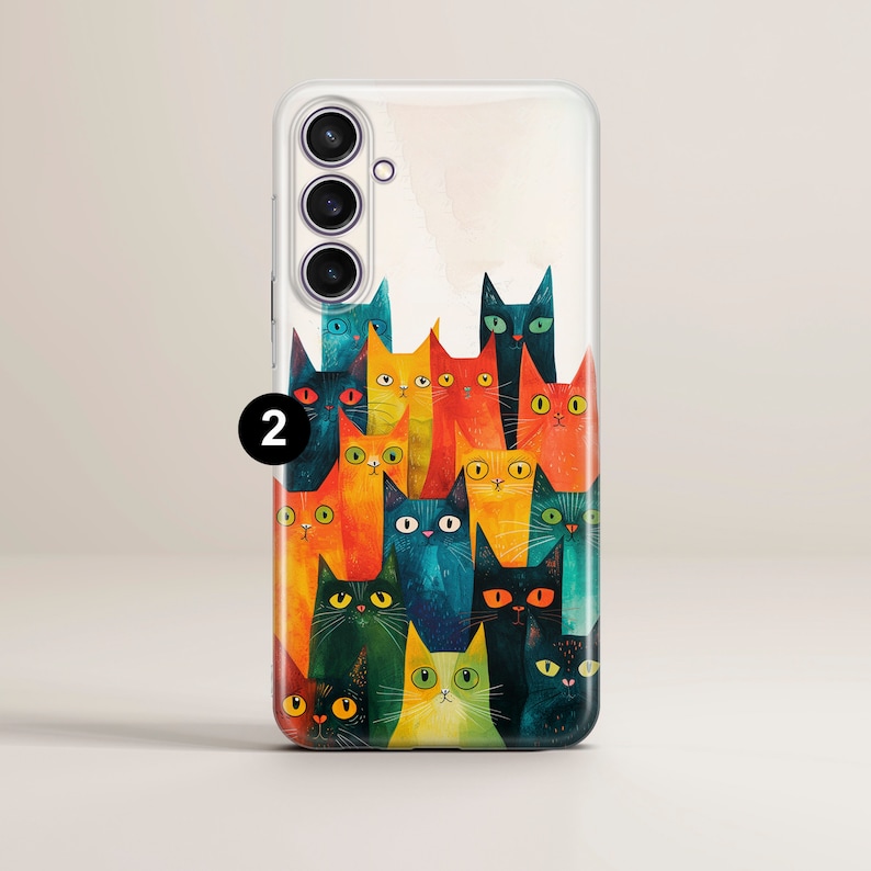 May include: A clear phone case with a colorful illustration of a group of cats. The cats are stacked on top of each other and have different colors and patterns. The phone case has a camera cutout on the back.