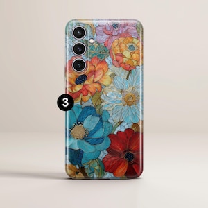 May include: A floral phone case featuring a vibrant design of colorful flowers in shades of red, orange, blue, and yellow. The case has a glossy finish and a number 3 is visible on the side.